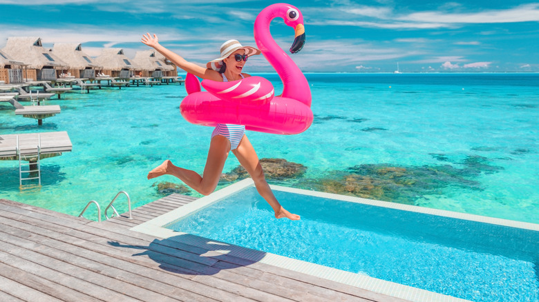 Happy woman with flamingo float