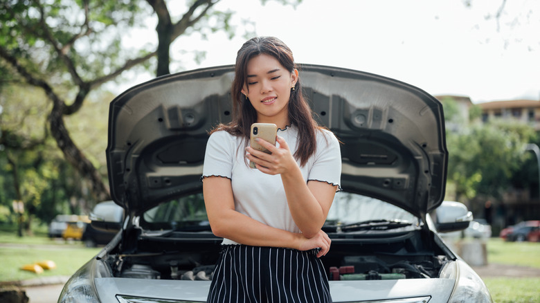 Woman near car using phone