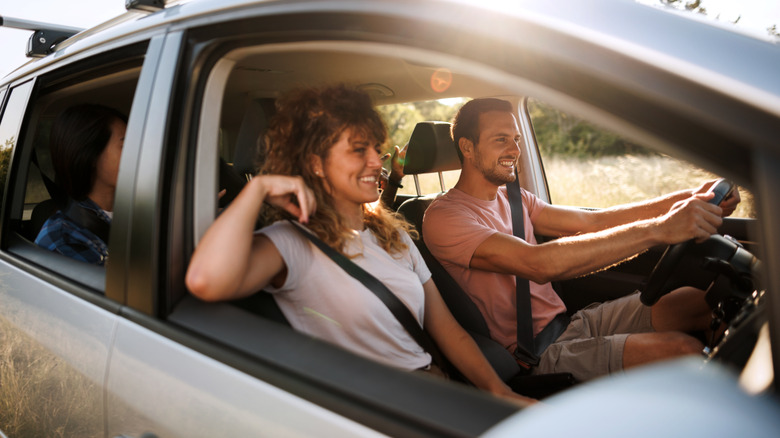 Smiling friends in car