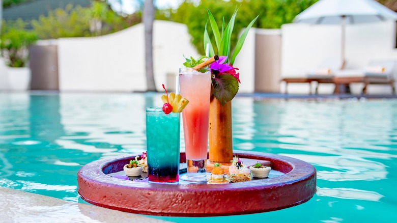 Cocktails floating on pool raft