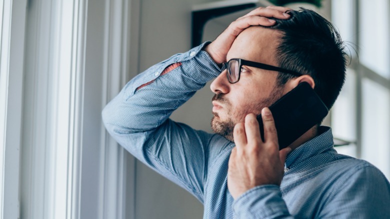 Bored man with phone to ear