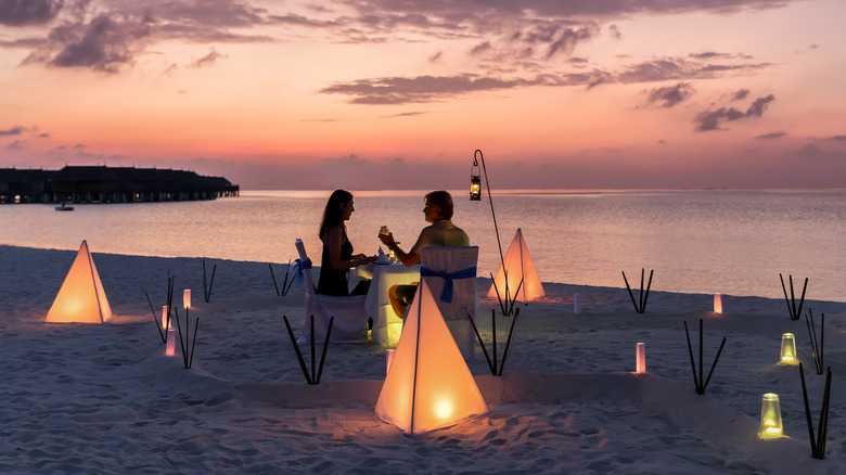 Couple private dining on beach
