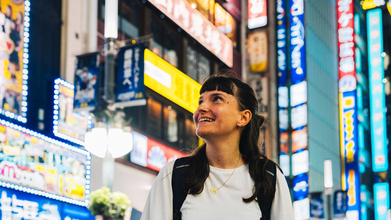 Traveler in Japan's Harajuku District at night