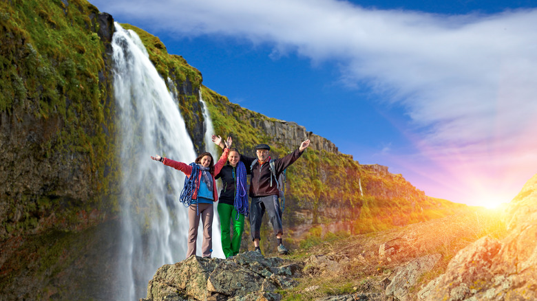 Hiking with friends at waterfall