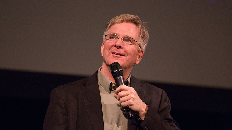 Rick Steves holding microphone