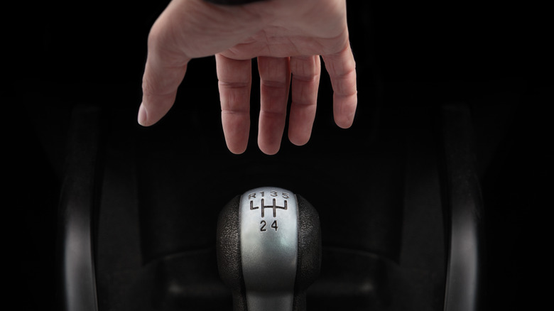 hand reaching for transmission shifter