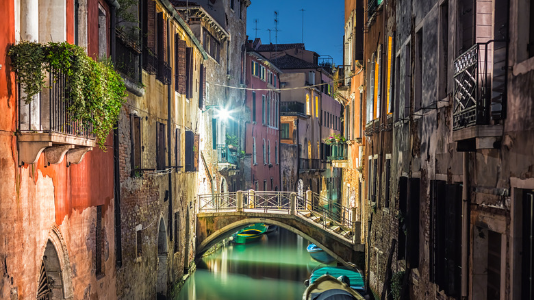 Venetian canal with gondola at night