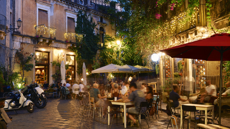 people dining outdoors in Italy