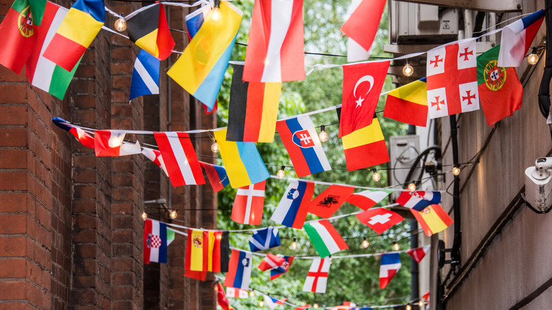 Small flags hanging on twine between buildings