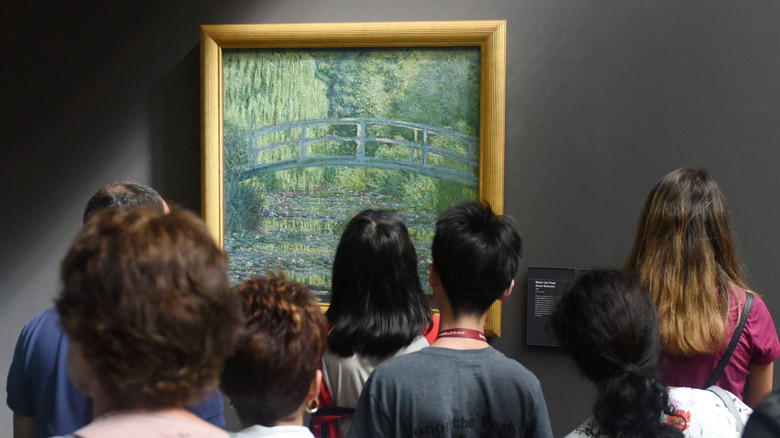 Tourists looking at a painting