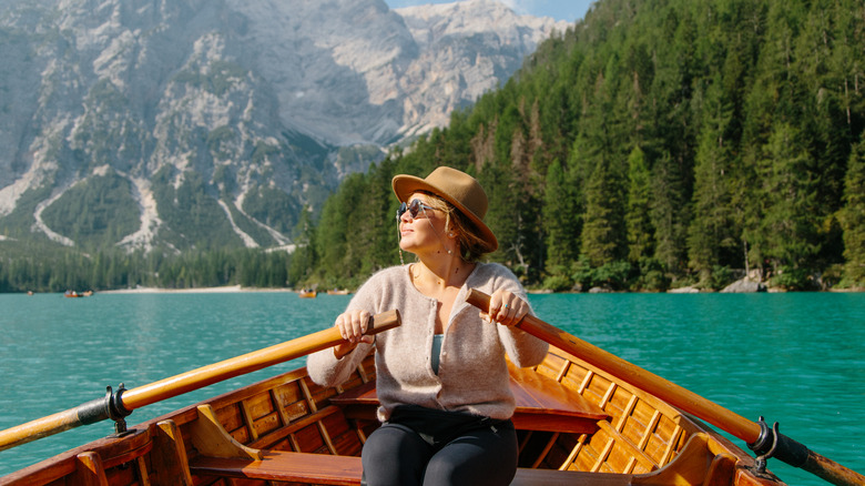 Woman rowing near Alps