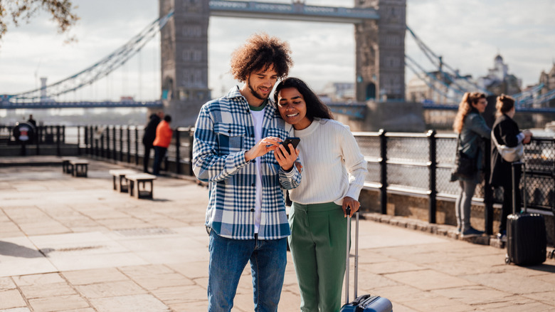 Traveling couple using phone