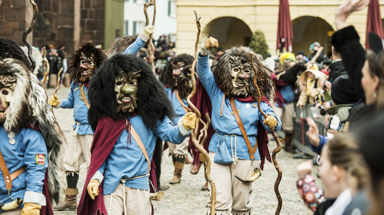 Locals dress in elaborate masks for a parade.