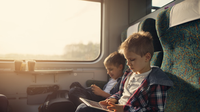Boys reading on a train