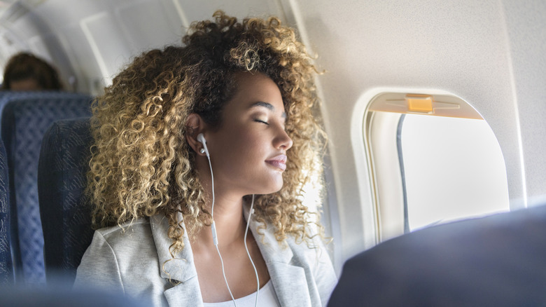 woman with earphones napping