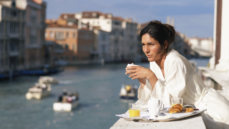 Woman having breakfast in Venice