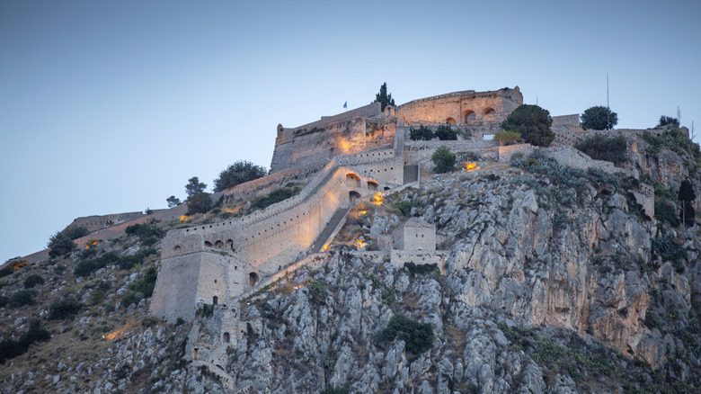 fortress on rocky hill at dusk