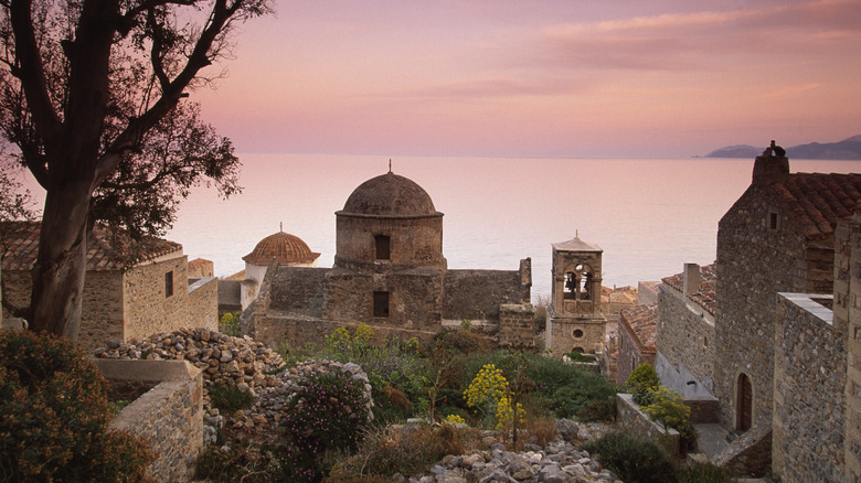 stone buildings sillhouetted against sunset