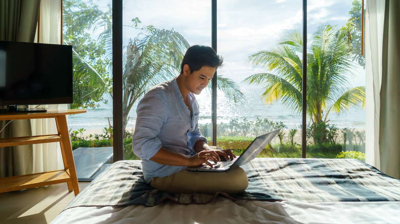 Man in hotel with laptop working