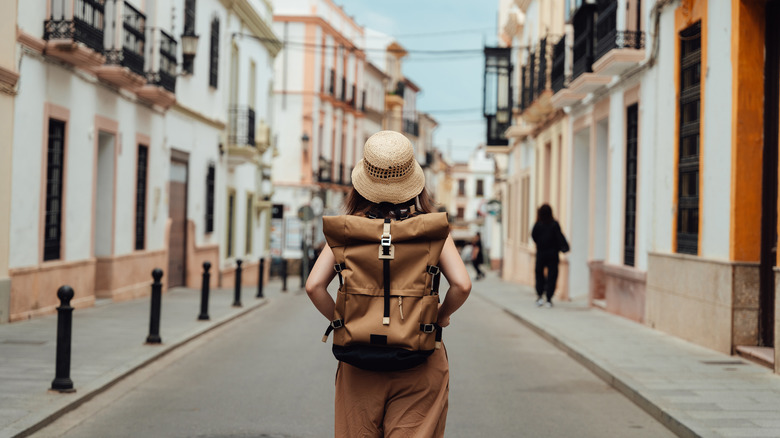 Woman with backpack on street