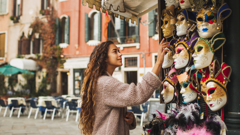 Woman looking at a stall selling masks