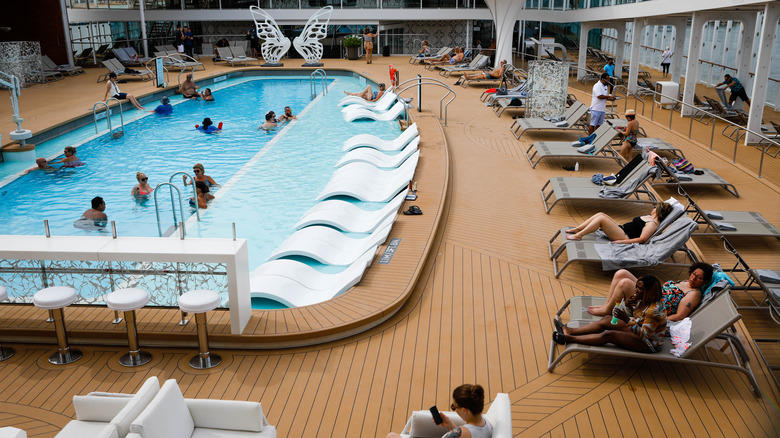 Cruise passengers lounging by pool