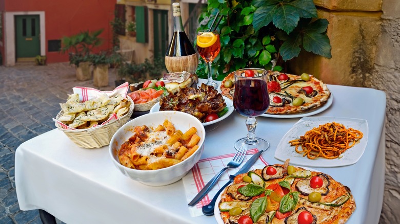 Pizza, pasta and wine on a table