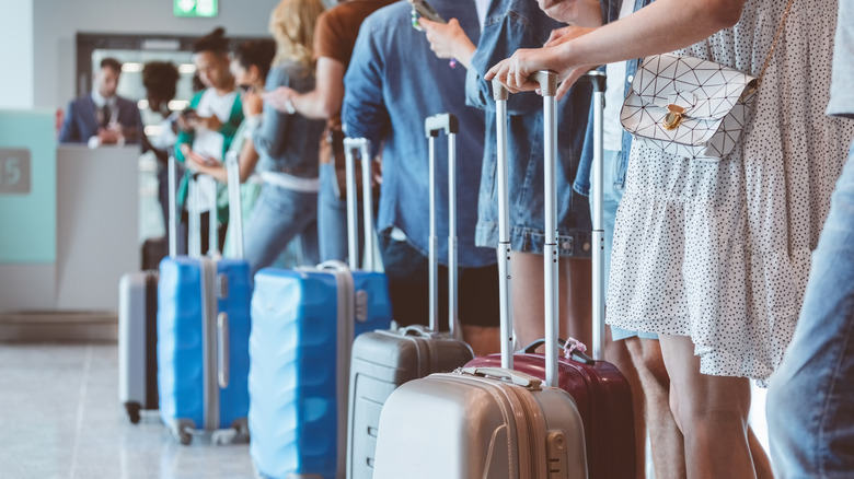 travelers lining up at boarding gate