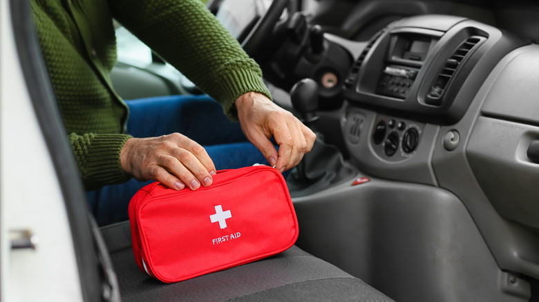 Person opening first aid kit