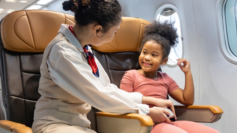 flight attendant helping child