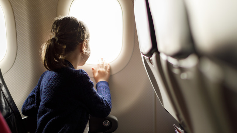 girl staring out plane window