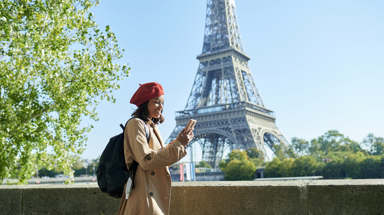 Woman looking at her phone in Paris