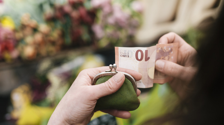 Hands holding a 10 euro note