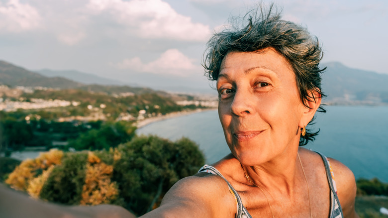 Lady takes a selfie in front of the sea