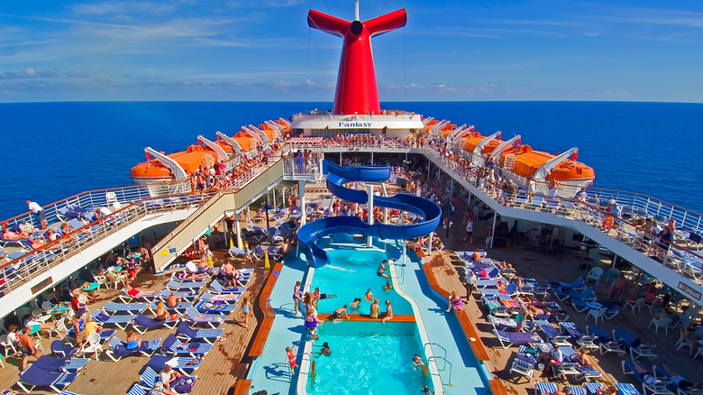 tropical cruise ship with pool and swimmers