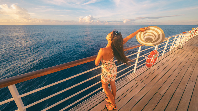 happy woman on deck of cruise ship at sea