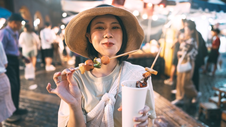 Tourist eating at night market