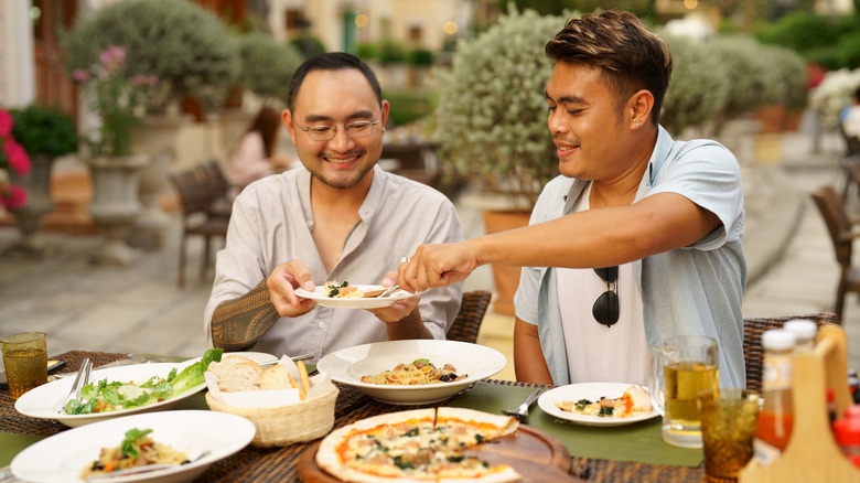 Men eating at outdoor restaurant