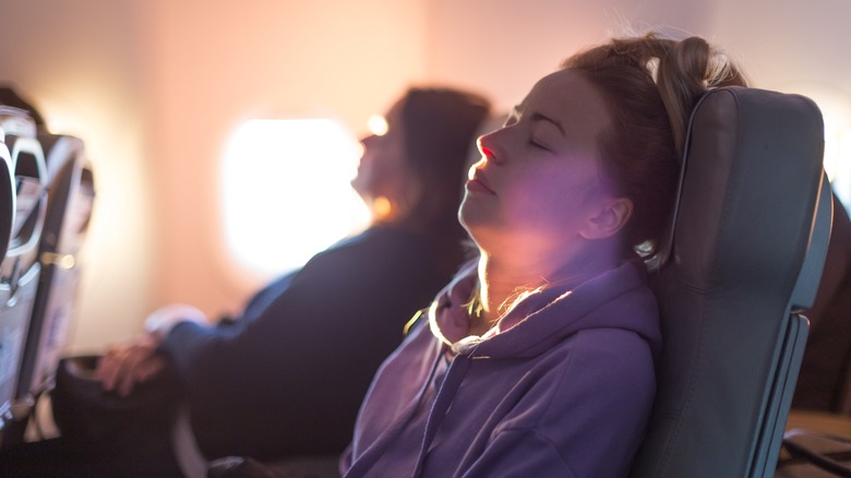 Traveler napping on airplane