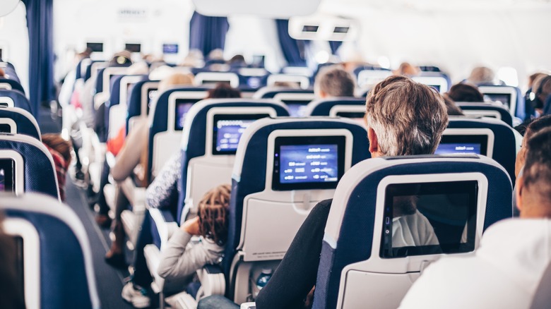 Rows of airplane seats with passengers