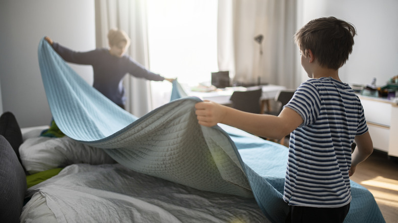 Kids making the bed