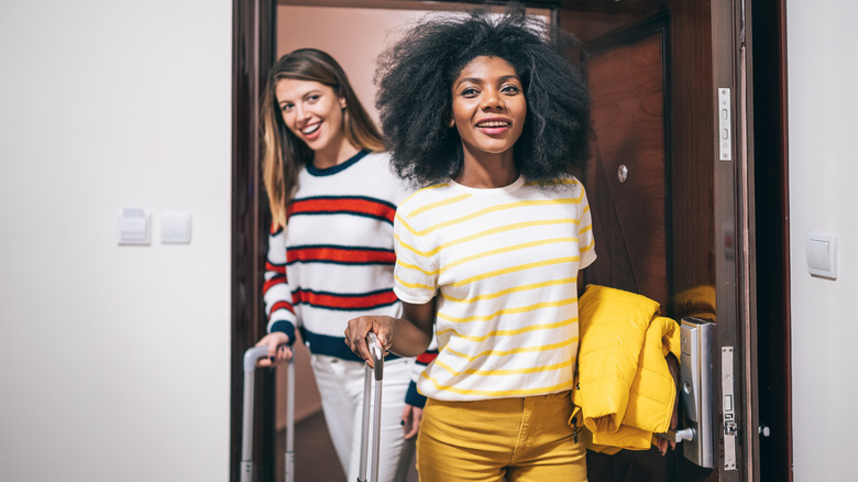 Two travelers leaving hotel room