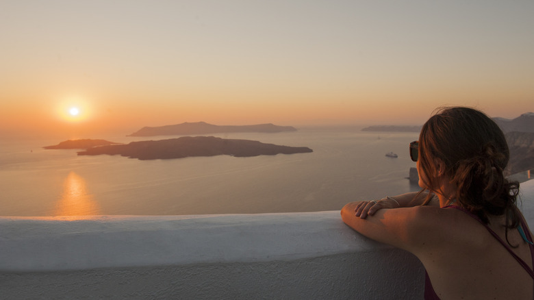 Traveler watching sunset in Santorini