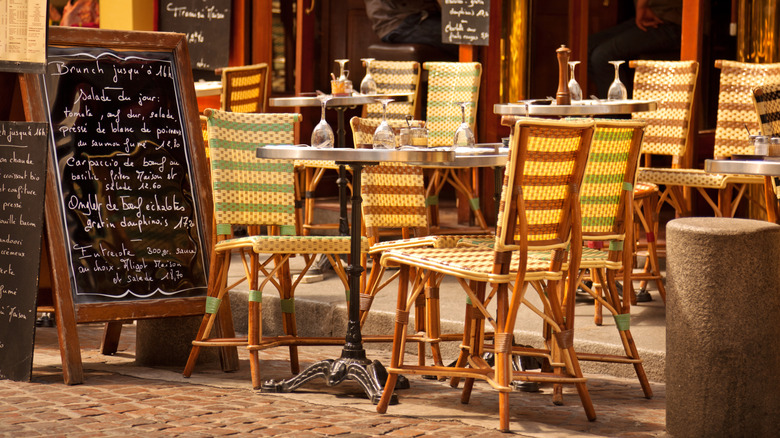 empty cafe tables next to a menu board