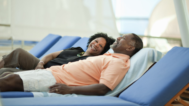 Cruise couple laying on sunbeds