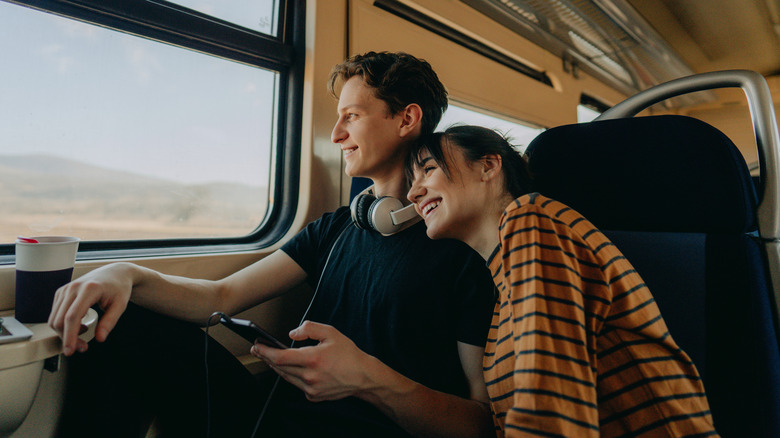 smiling couple on train