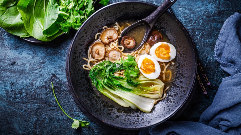 A wok containing ramen and other ingredients