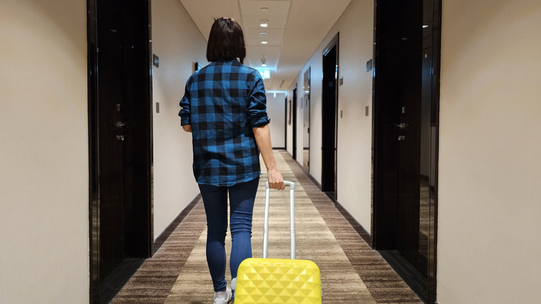 Woman walking down cabin hallway