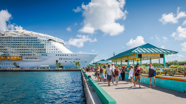 passengers getting off cruise ship at a port