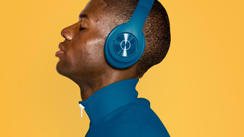 man wearing headphones on yellow background